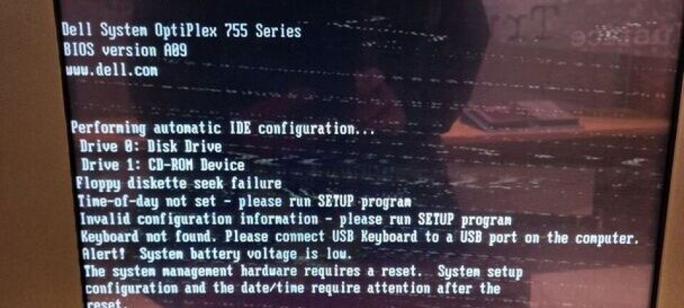 CRT monitor showing a Dell OptiPlex 755 BIOS screen with a low system battery warning.